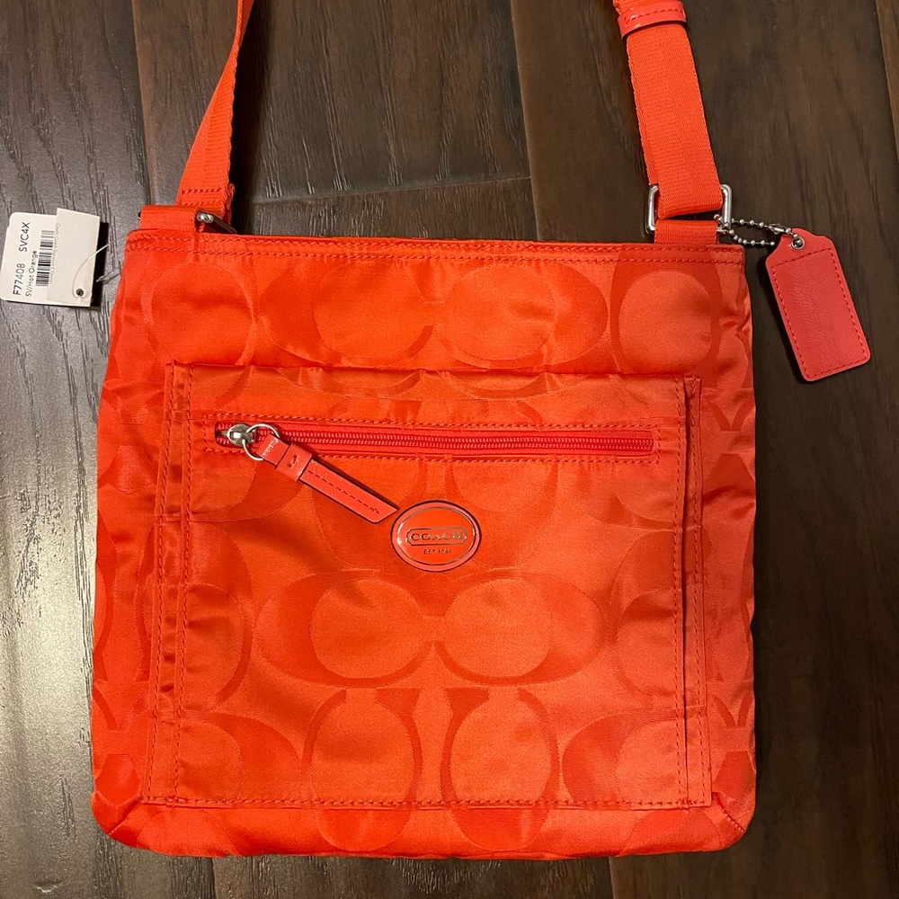 Coach purse new tags orange cross body. Adjustable strap